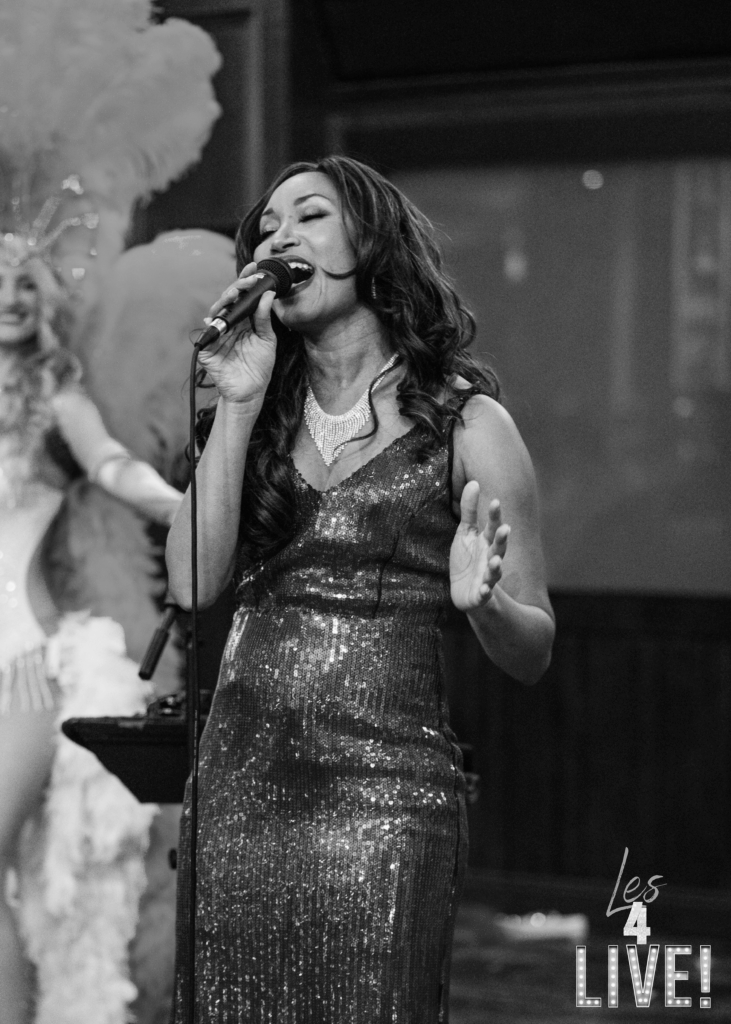 Vintage singer at the hardrock cafe with a dancing showgirl in the background