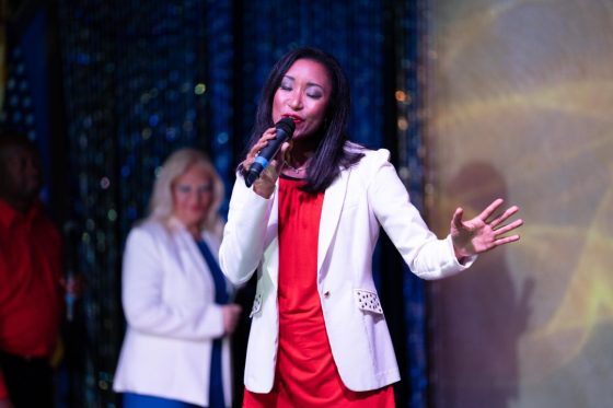Deanna L. Giron singing live at a dinner theater performance