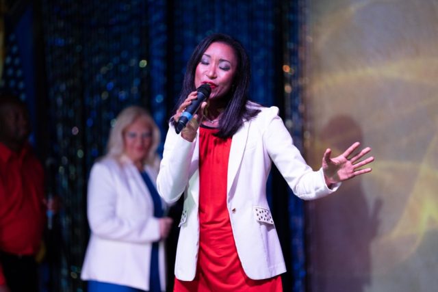 Deanna L. Giron singing live at a dinner theater performance