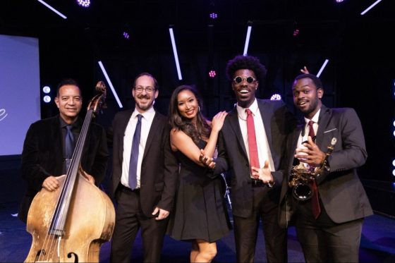 The Velvet Vibe band performing live, five pieces including upright bass and saxophone